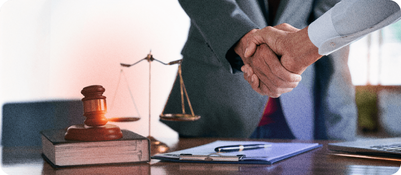 Lawyer handshake and legal balance